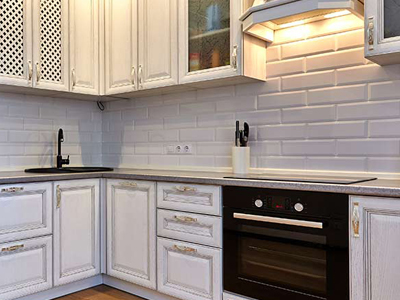 white brick kitchen backsplash and cabinets